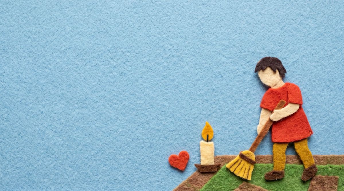 Felt figure sweeping the floor