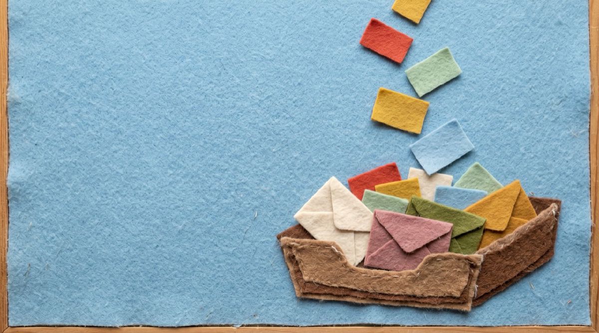 Felt letters flying toward a single mailbox