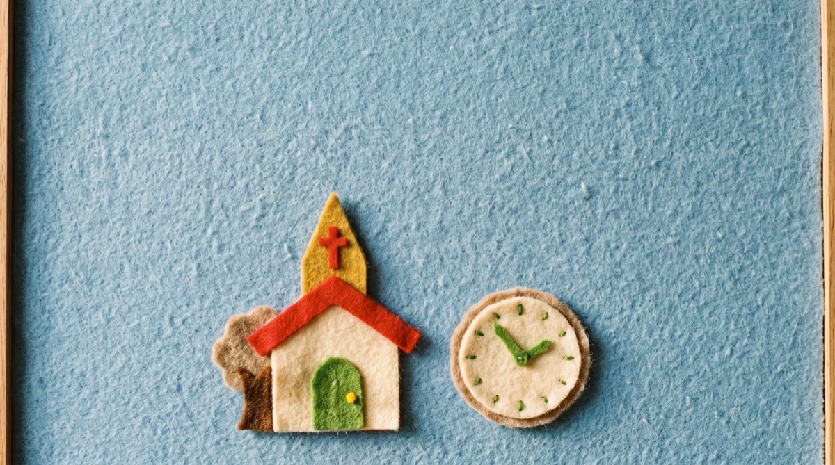 Felt-board church beside a felt clock